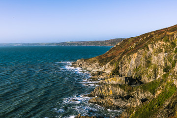 Rocky coastline and ocean waves in Cornwall, UK