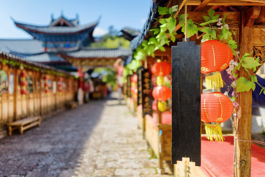 Traditional Chinese red street lanterns and black wooden boards
