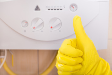 Thumb up in front of gas boiler