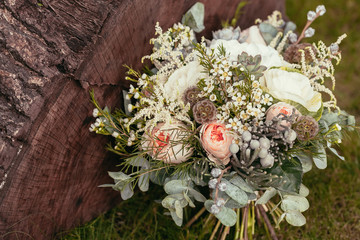 rustic wedding bouquet with roses and succulents on green grass - 101111637