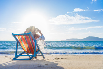 Woman at beautiful beach on a sunbed