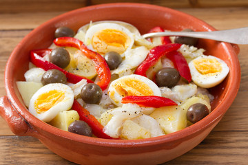 traditional portuguese dish on ceramic plate on brown wooden background