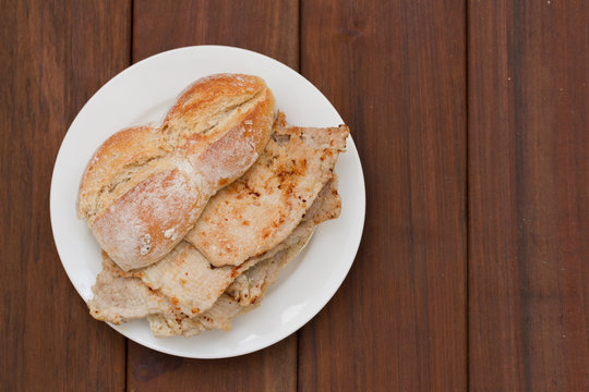 typical portuguese dish bifanas vendas novas on white plate on brown wooden background