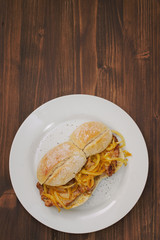 typical portuguese dish bifanas vendas novas on white plate on brown wooden background