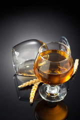 cognac and  glass  on black