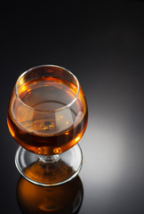 cognac and  glass  on black