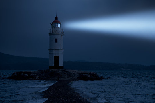 Lighthouse in Vladivostok shines at night in the sea