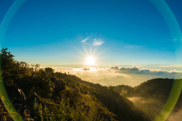Naklejka na ściany i meble Morning landscape of sunrise over mountains peak with fog