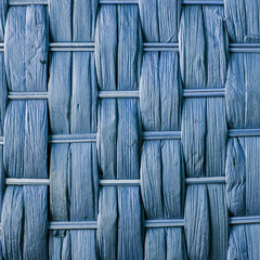 Imaginative blue woven reed / wood abstract background texture.