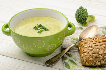 Broccoli cream soup on the wooden table.