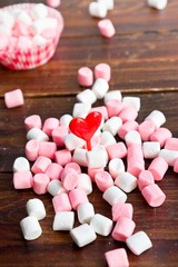 Fototapeta na wymiar Marshmallows with hearts on wooden background