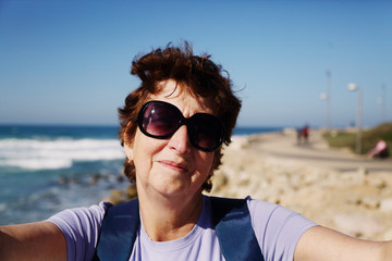 Portrait of happy senior woman traveling