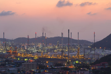 Oil refinery with water vapor in Hamburg, Germany, petrochemical industry during twilight.