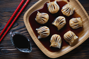 Bamboo tray with prawn hargows and soy sauce, view from above