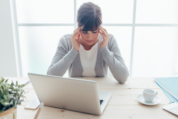 Exhausted businesswoman with headache