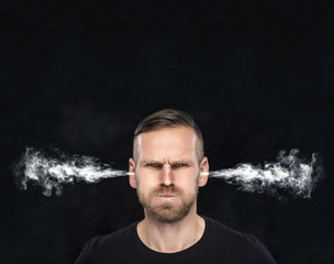 Angry man with smoke coming out from his ears.