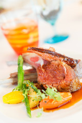 Lamb steak with sauce and boiled vegetables