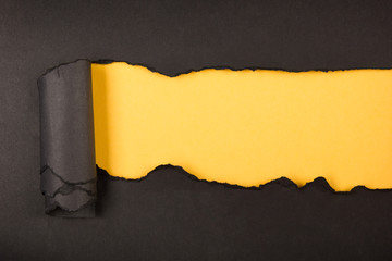 Ripped paper, space for copy. Black and yellow background.