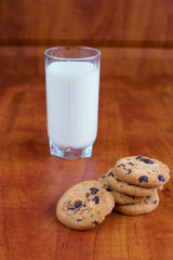 
Breakfast with milk and chocolate chip cookies on the table. wooden background