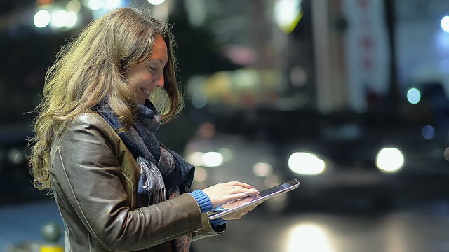 Young Girl with a Tablet in the Night City