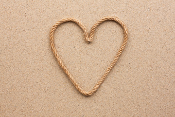 Heart made of rope on the sand