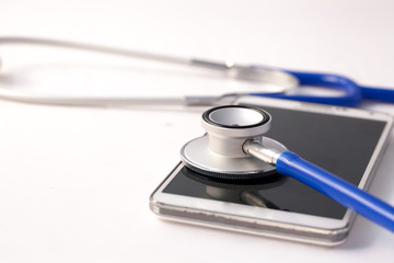 Smartphone being diagnosed by stethoscope - phone repair and check up concept