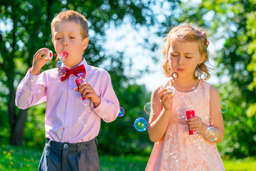 Portrait child with soap bubbles on a summer day