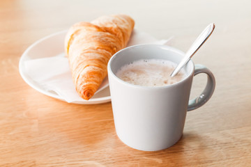 Cappuccino with croissant. Cup of coffee