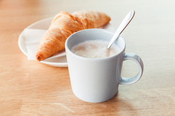 Cappuccino and croissant. Modern breakfast theme