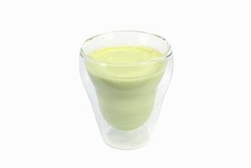 Green tea latte beverage in double wall glass mug.