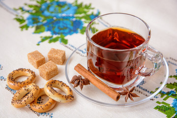 Cup of tea with brown sugar, anise, cinnamon and bagels