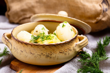 Boiled potatoes sprinkled with dill is in the pot.