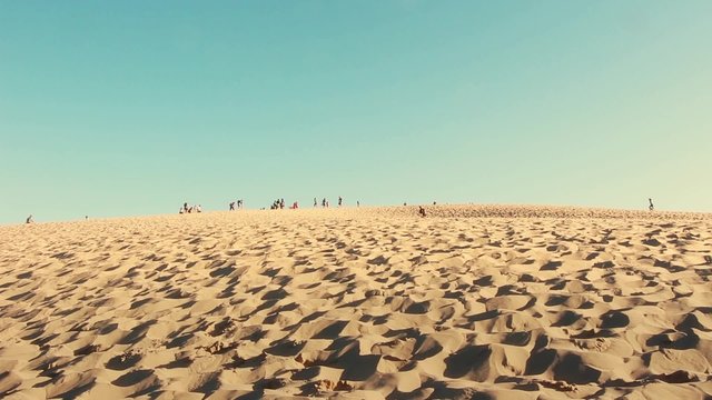 Crowd on Top of Great Dune of Pyla, France. The Dune of Pyla with tourists passing by - The highest sand dune of Europe - full HD