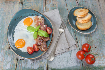 Fried eggs,  bacon, tomato and toast