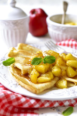 Thin pancakes with caramelised apples and cinnamon.