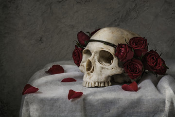 Still life photography with human skull and roses