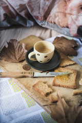 a representation of breakfast time on bed, with coffee espresso, rusks with marmelade, typical mediterranean breakfast