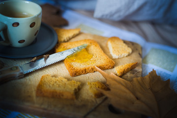 a representation of breakfast time on bed, with coffee espresso, rusks with marmelade, typical mediterranean breakfast