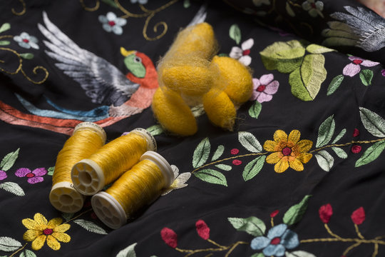 raw silk, bobbins and silk embroidered cloth