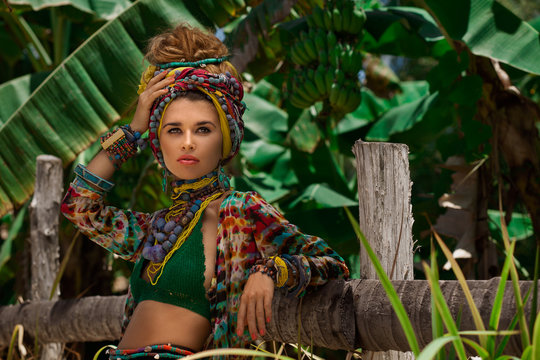 Fashion model posing outdoors with jungle background