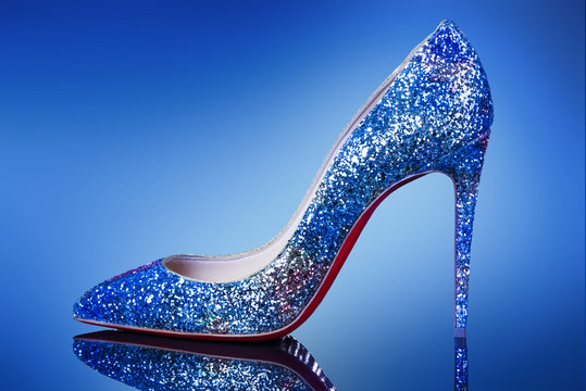Woman shoe on high heel on the blue background.