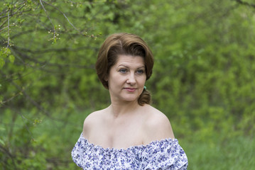 Portrait of an elegant woman in  dress with bare shoulders