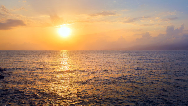 Beautiful seascape at sunrise. Sun reflection in sea water at dawn. Panoramic shot. Toned image.