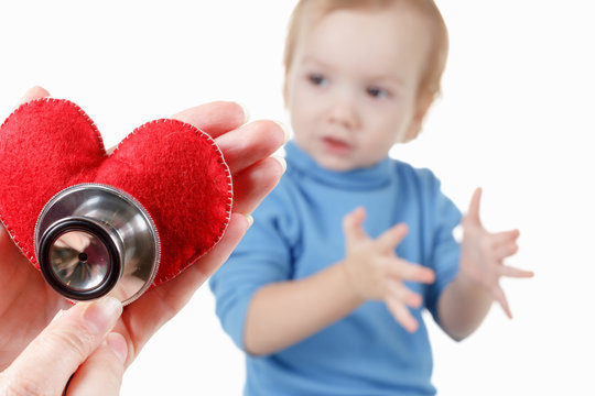 Child And Cardiologist, Heart Symbol In Hand, Stethoscope.