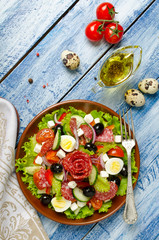 Salad with fresh vegetables, feta cheese, quail eggs, olives and