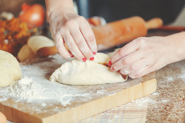 Female hands fasten halves patty