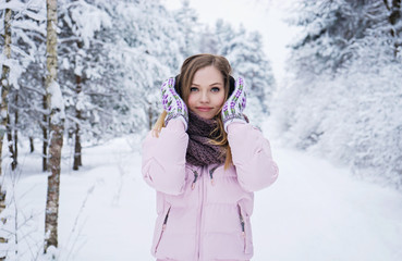 Fototapeta na wymiar Young woman winter portrait in snowly forest