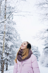 Young woman winter portrait in snowly forest