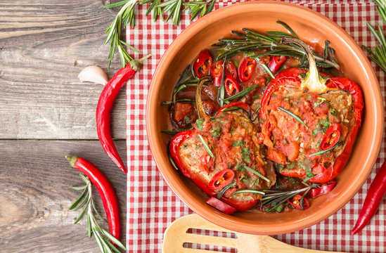 Stuffed red peppers with spicy tomato sauce and rosemary