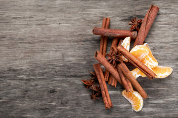 Cinnamon sticks and anice on wooden table. selected focus